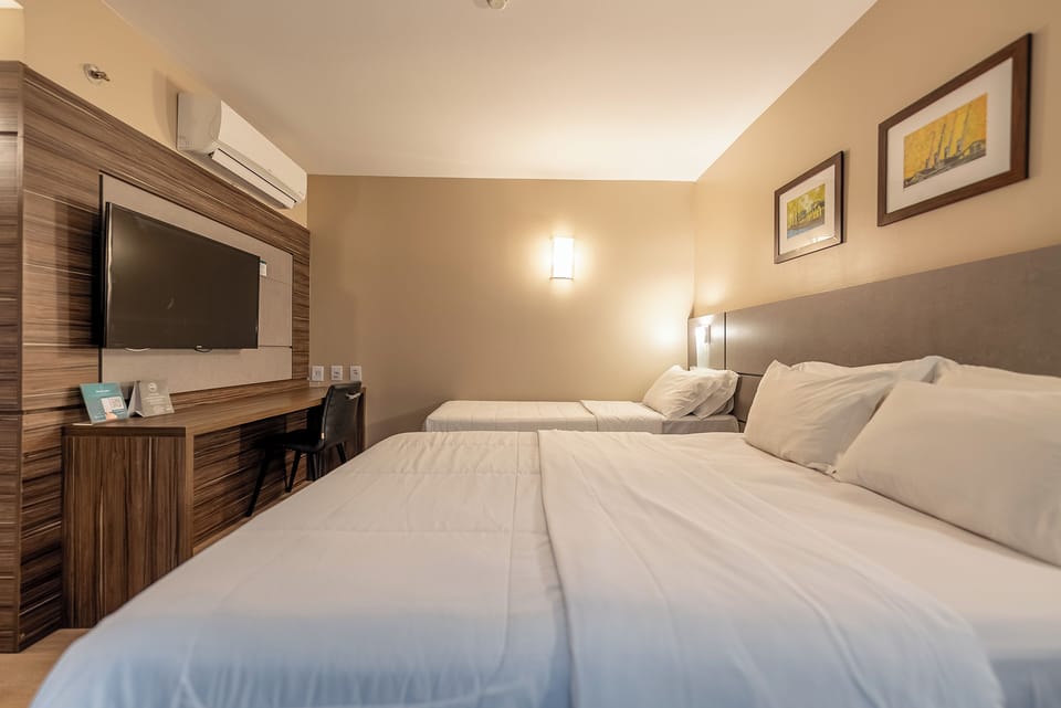 Deluxe Triple Room | In-room safe, desk, laptop workspace, blackout drapes