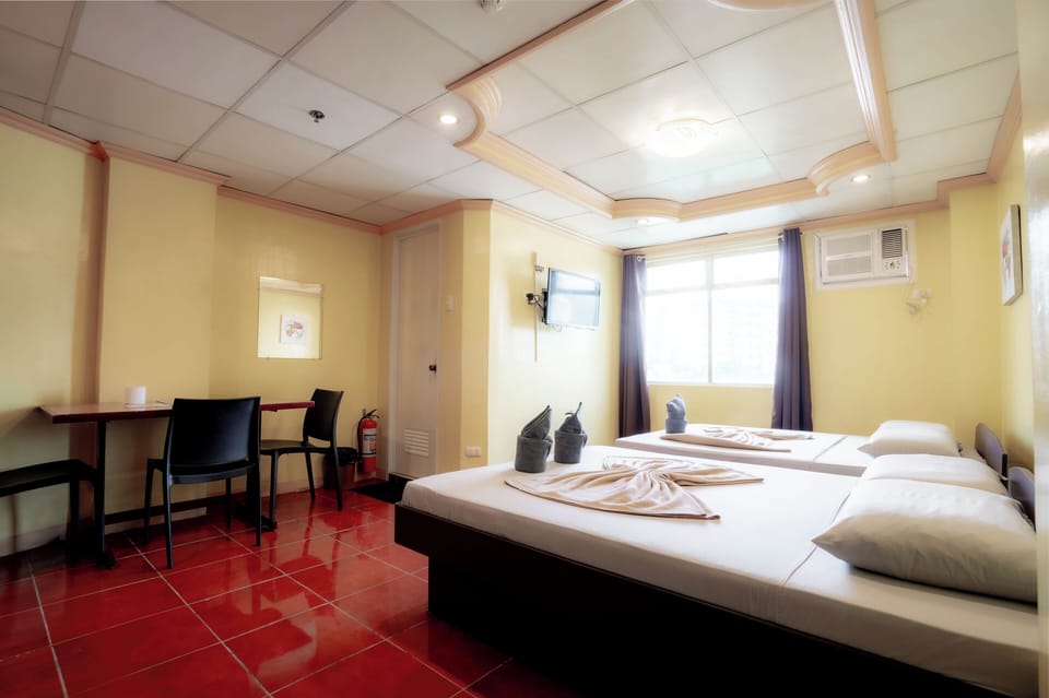 Deluxe Triple Room, Accessible, City View | Desk, bed sheets