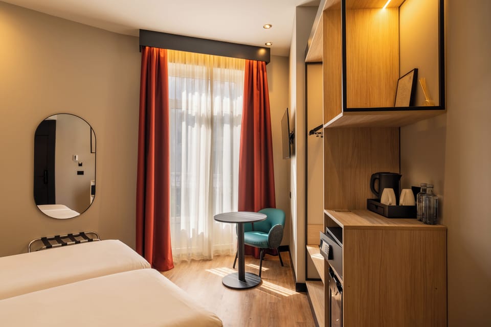 Standard Double Room | Minibar, in-room safe, desk, blackout drapes