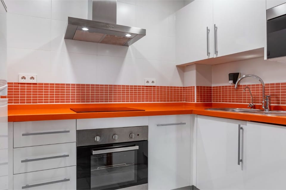 A kitchen space that balances color and functionality, equipped for preparing meals and making memories.