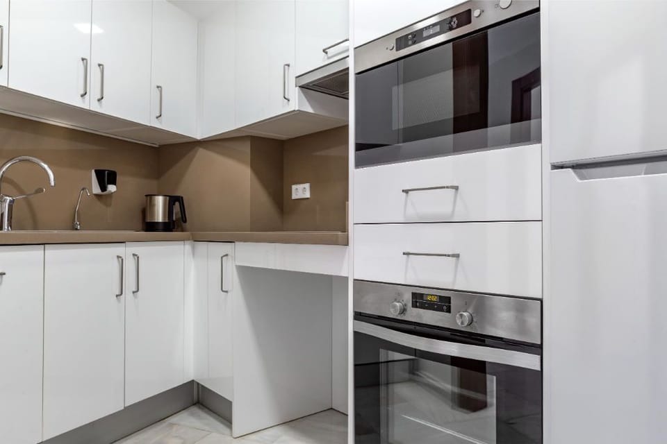 Ultra-modern kitchen with high-end appliances, set in a clean and monochromatic design.