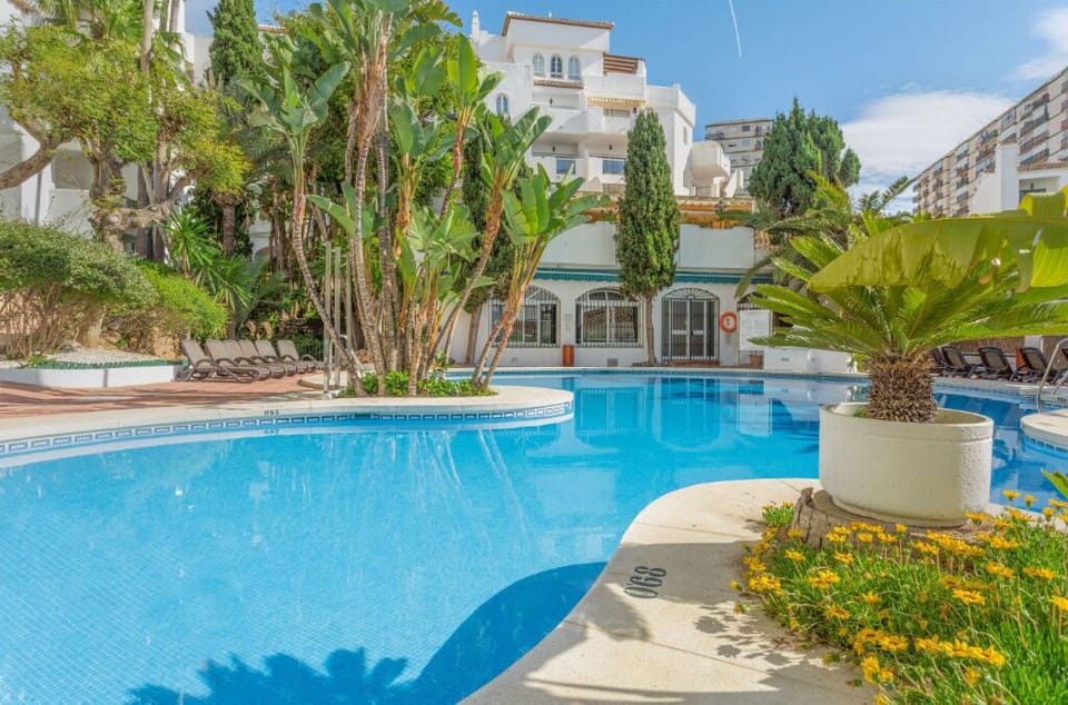 Refresh and unwind in a tranquil pool oasis, surrounded by lush foliage.