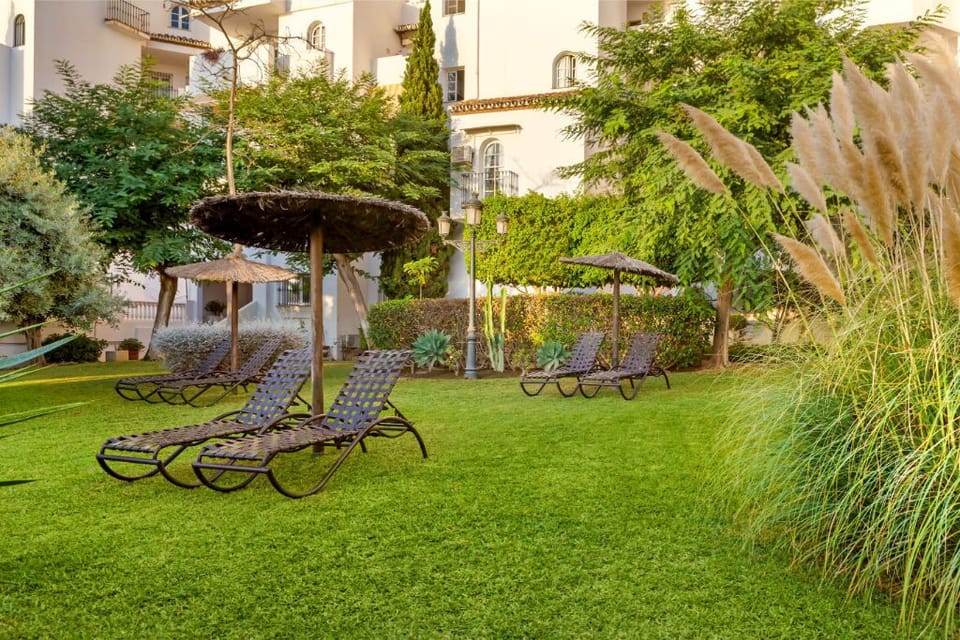 A secluded pool framed by verdant greenery and sun-kissed terraces for ultimate privacy.
