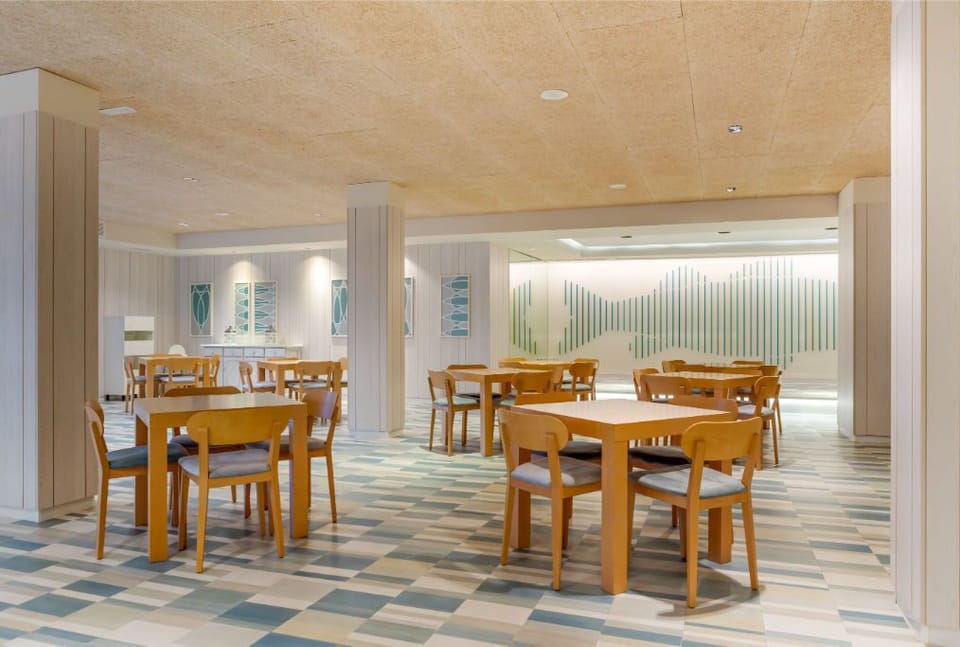 A bright dining nook with natural light spilling over a classic wooden table, inviting intimate meals and lively conversations.