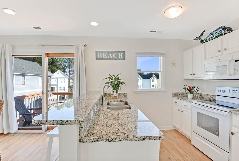 Island with counter in the kitchen provides additional seating 