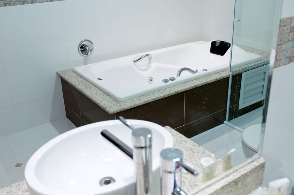 Suite, Jetted Tub | Bathroom | Shower, free toiletries, hair dryer, towels