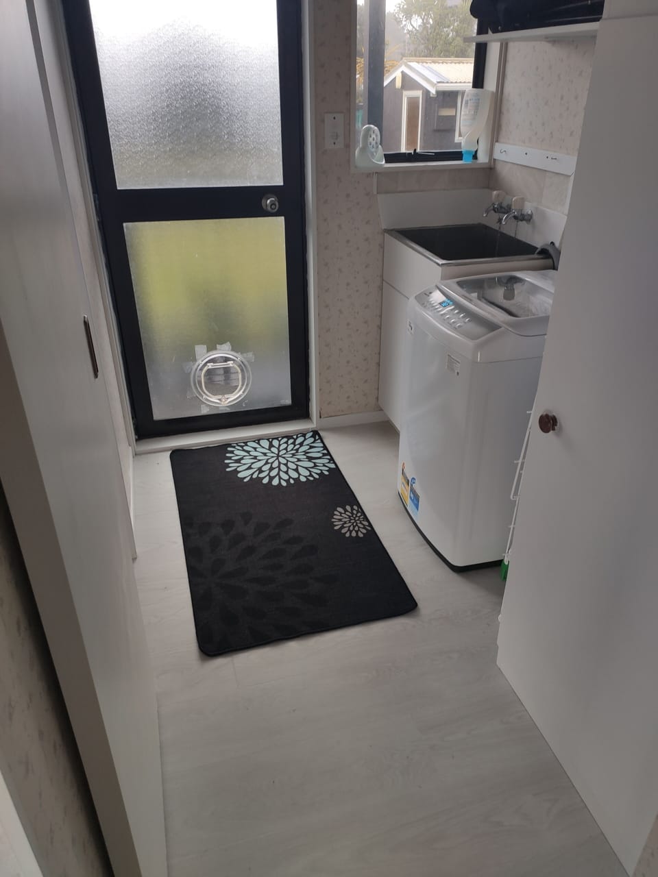 Laundry: washing machine, iron, ironing board, clothes rack.