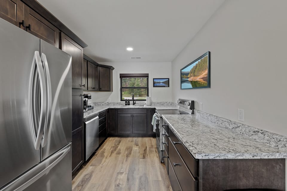 Electric Stove, Full Oven, Full Sized Fridge/Freezer, Dishwasher, Microwave.