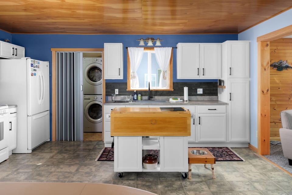 Kitchen plus utility area with washer/dryer.  Living rm to right, bath/beds left