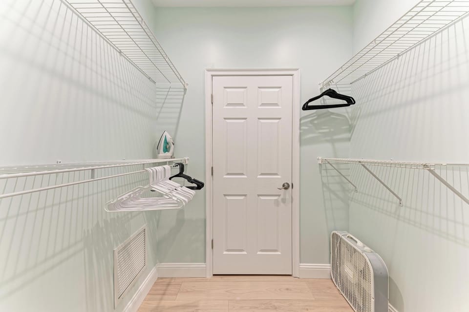 Your walk-in closet features abundant hanging space, built-in shelving, and a convenient ironing board—perfect for keeping your wardrobe organized and wrinkle-free during your stay.