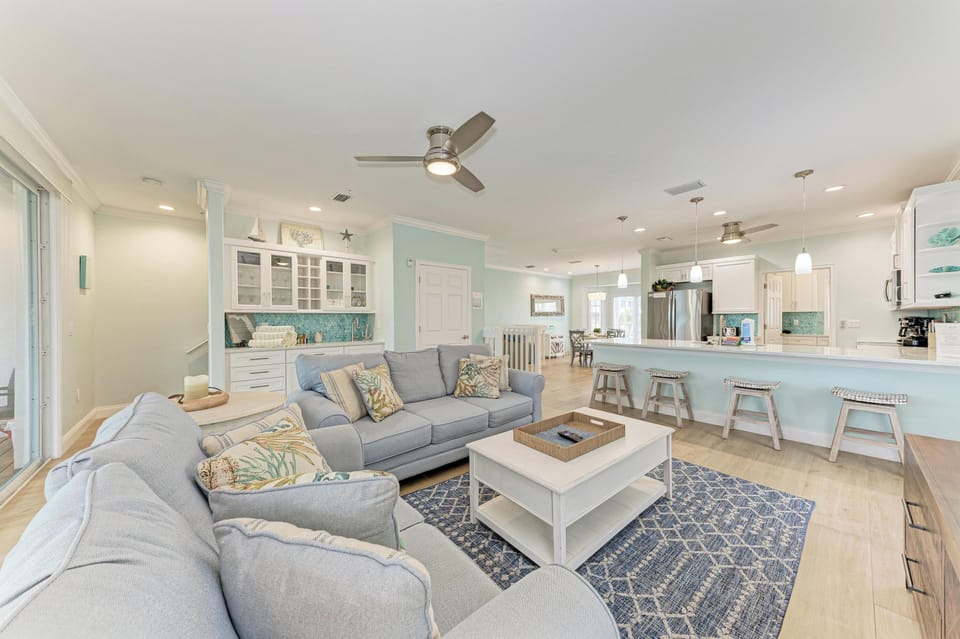 Your spacious open living area flows seamlessly into a bright kitchen, complete with a breakfast bar perfect for morning coffee and casual meals together.