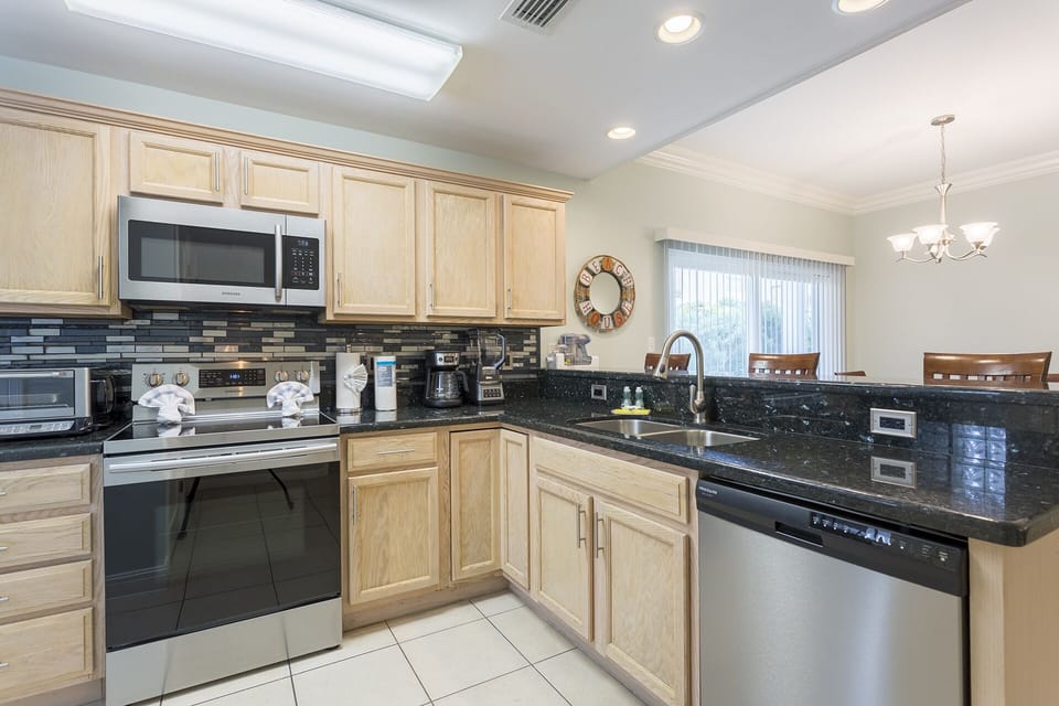 Fully equipped kitchen with granite countertops and stainless steel appliances.