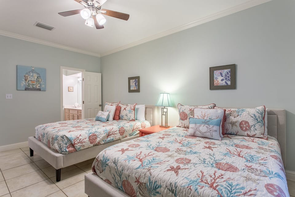 Comfortable guest room with two Queen beds and a flat-screen TV.