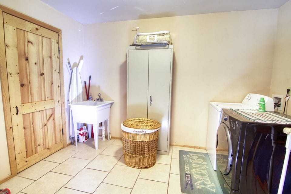 Laundry room including ironing board and iron