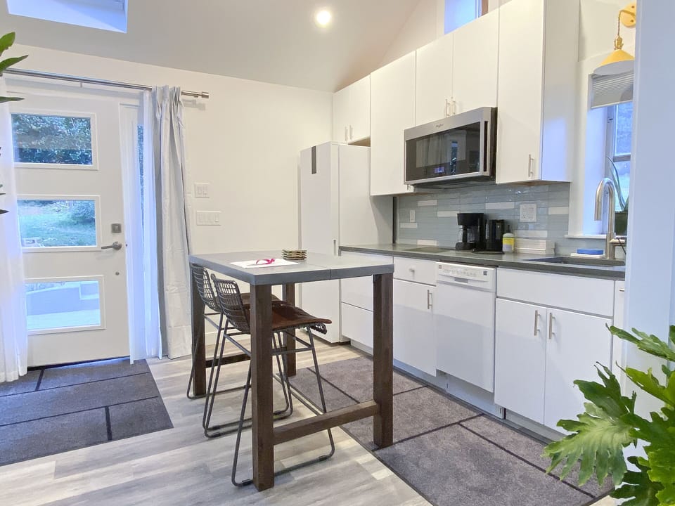 Kitchenette and table. Microwave also works as an oven. 2 Induction cooktops.
