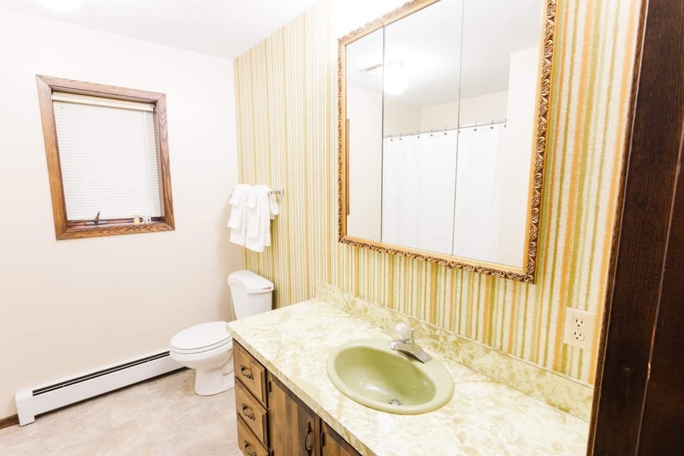 Downstairs bathroom with large single vanity.