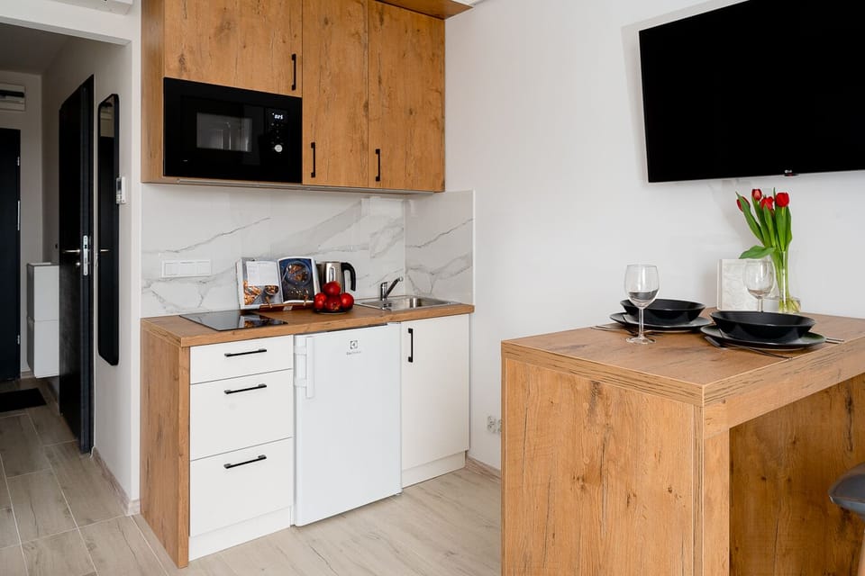Design Apartment | Private kitchen | Fridge, microwave, stovetop, highchair