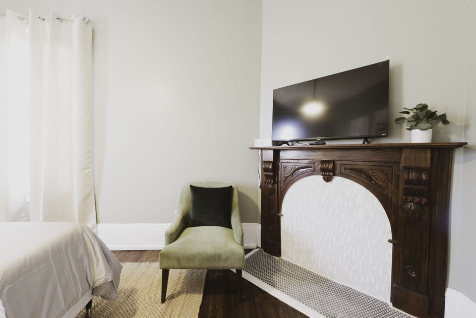 The Pulaski Room is a private bedroom with queen bed, smart TV, and desk.