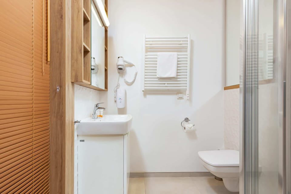 Bathroom with washing machine and towels. 