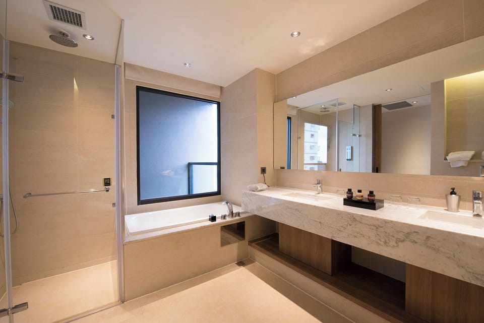 Signature Quadruple Room | Bathroom | Hair dryer, slippers, towels