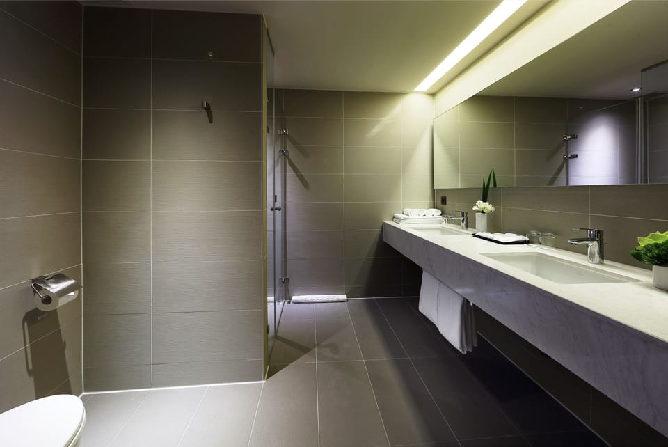Deluxe Quadruple Room, 2 Double Beds | Bathroom | Shower, hair dryer, slippers, towels