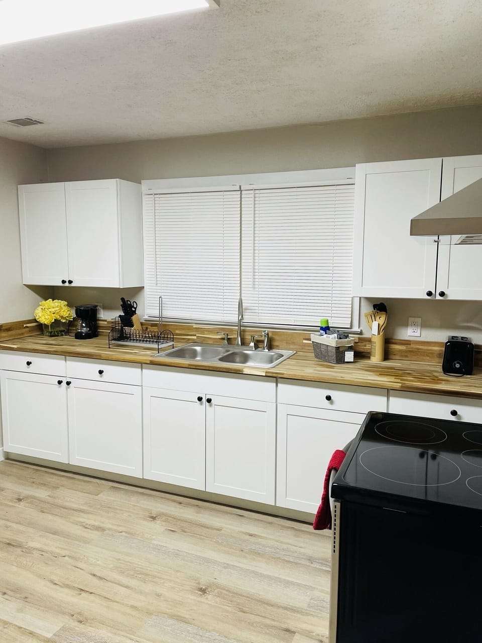 Bright and airy kitchen with new appliances and butcher block countertops. 
