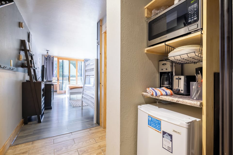 Equipped with a mini fridge, toaster, coffee maker, and more.