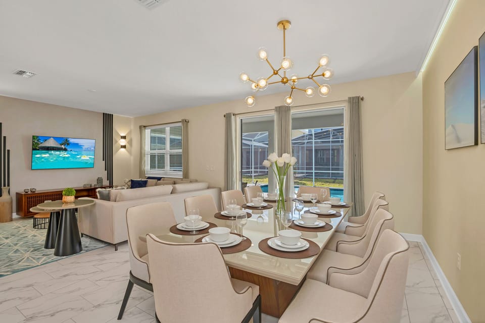 Open dining and living area seamlessly connected for easy entertaining and relaxation - Sophisticated decor with a chic chandelier and spacious seating for every guest - A bright, inviting space that brings everyone together in style and comfort