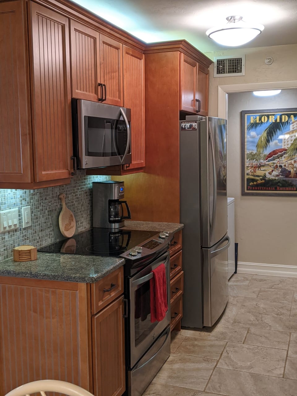 Modern kitchen with large capacity washer & dryer behind