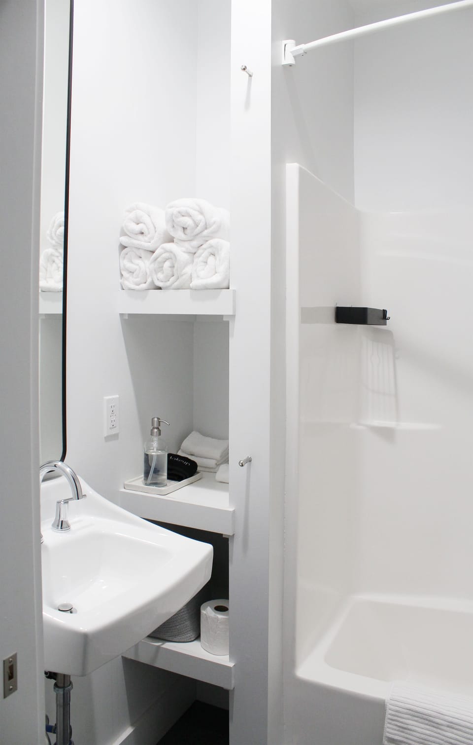 Conveniently placed hallway bath with pocket door and large mirror.