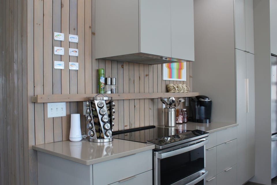 Fully stocked kitchen with stained wood accent wall!