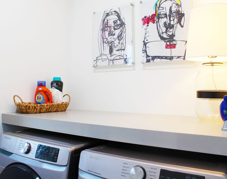 Stocked laundry with folding / storage ledge and dust buster.