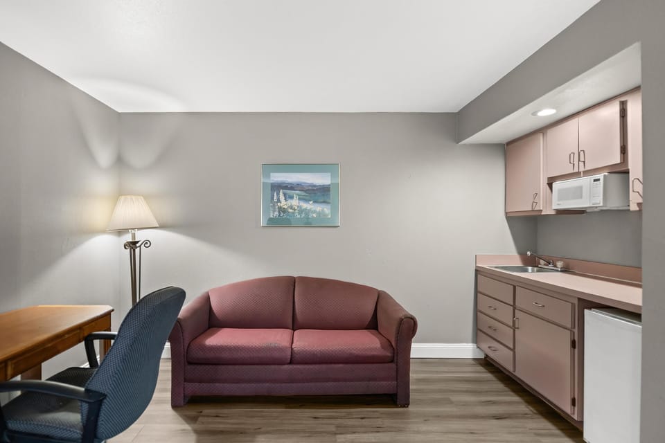 Suite, 1 King Bed, Kitchenette | Desk, laptop workspace, blackout drapes, iron/ironing board
