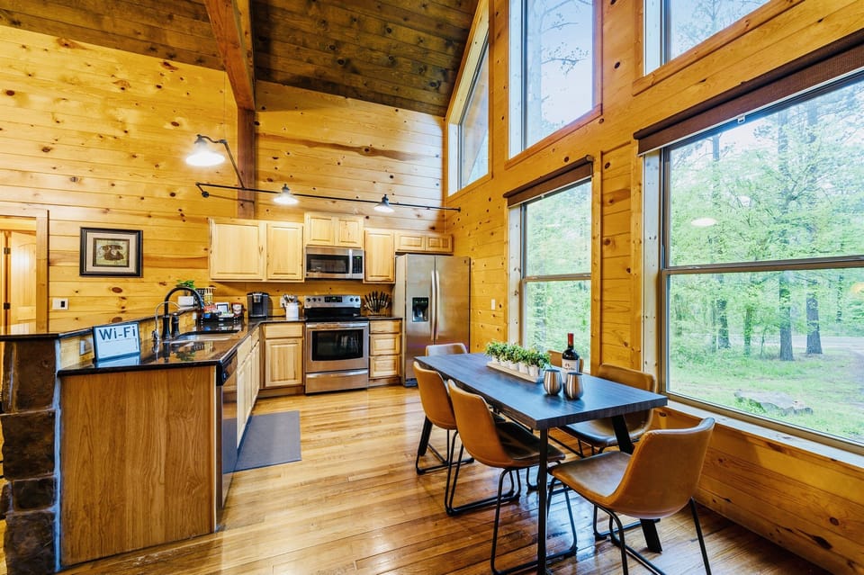 Fully stocked kitchen with high ceilings and open windows for an airy, nature-inspired feel.