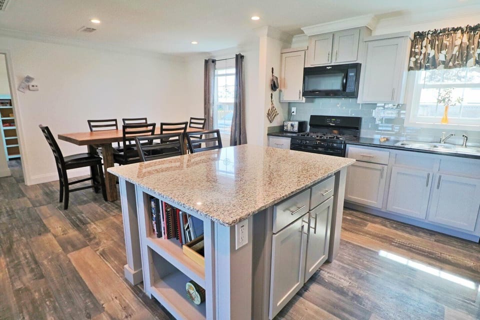 The dining area includes seating for 8 including the breakfast bar.