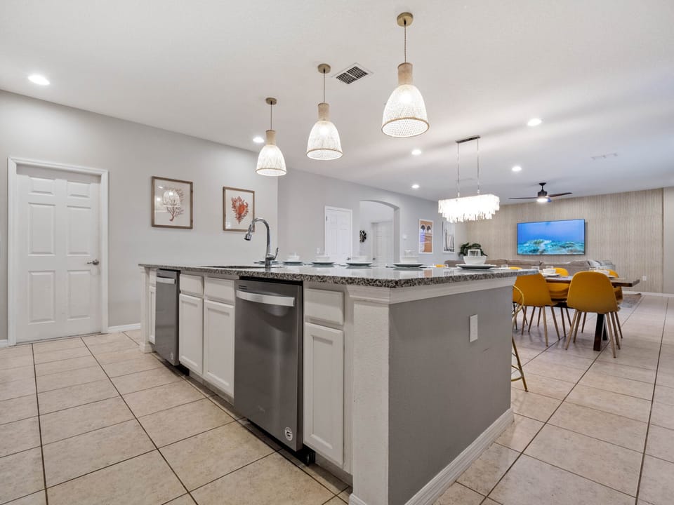 - Bright open kitchen featuring granite counters and breakfast bar seating  
- Pendant lighting and modern appliances create a welcoming cooking space  
- Perfect for group dining with open flow into living and dining areas