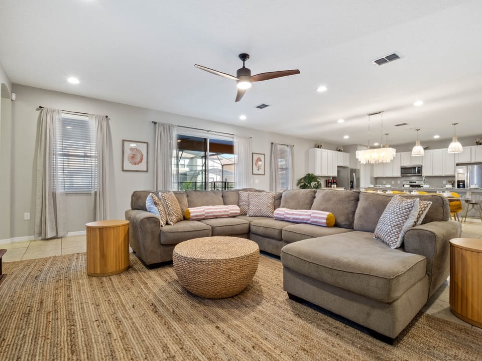 - Living room with sectional sofa and natural light  
- Cozy Florida rental with entertainment space  
- Vacation rental designed for family comfort stay