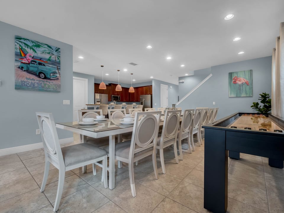- Large dining table with seating for big groups perfect for vacation stays  
- Bright wall art and shuffleboard bring fun energy to family meals  
- Ideal for group-friendly rentals near Orlando attractions