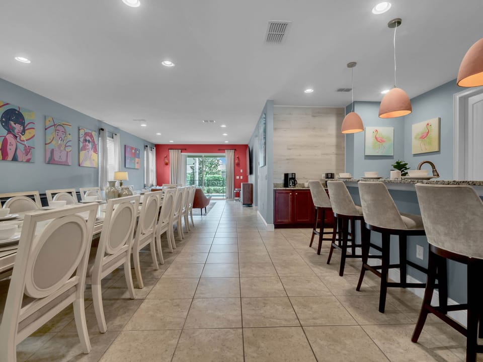 - Long dining table seating the entire group for shared meals and gatherings  
- Bright decor with artistic wall accents perfect for family getaways  
- Open dining room leads into living area for group-friendly layout