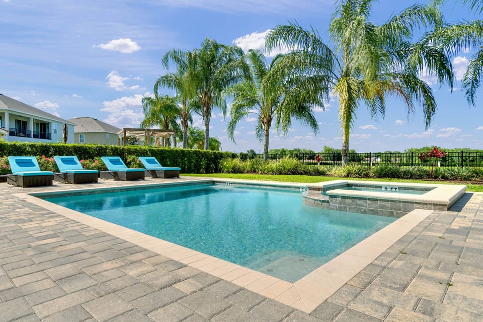 - Private pool with crystal clear water and relaxing hot tub spa  
- Palm trees and lounge chairs create a perfect outdoor escape  
- Spacious patio with sun-soaked views for relaxation and fun
