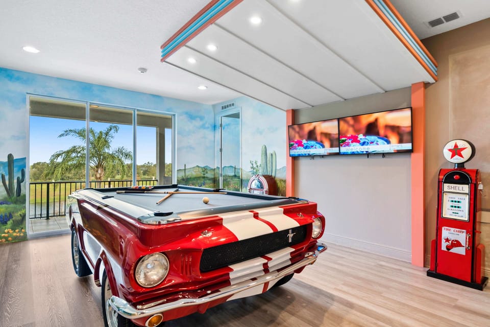 - Game room with classic Mustang pool table centerpiece design  
- Wall murals, jukebox, and twin TVs create arcade style fun  
- Bright playful space perfect for family game nights together