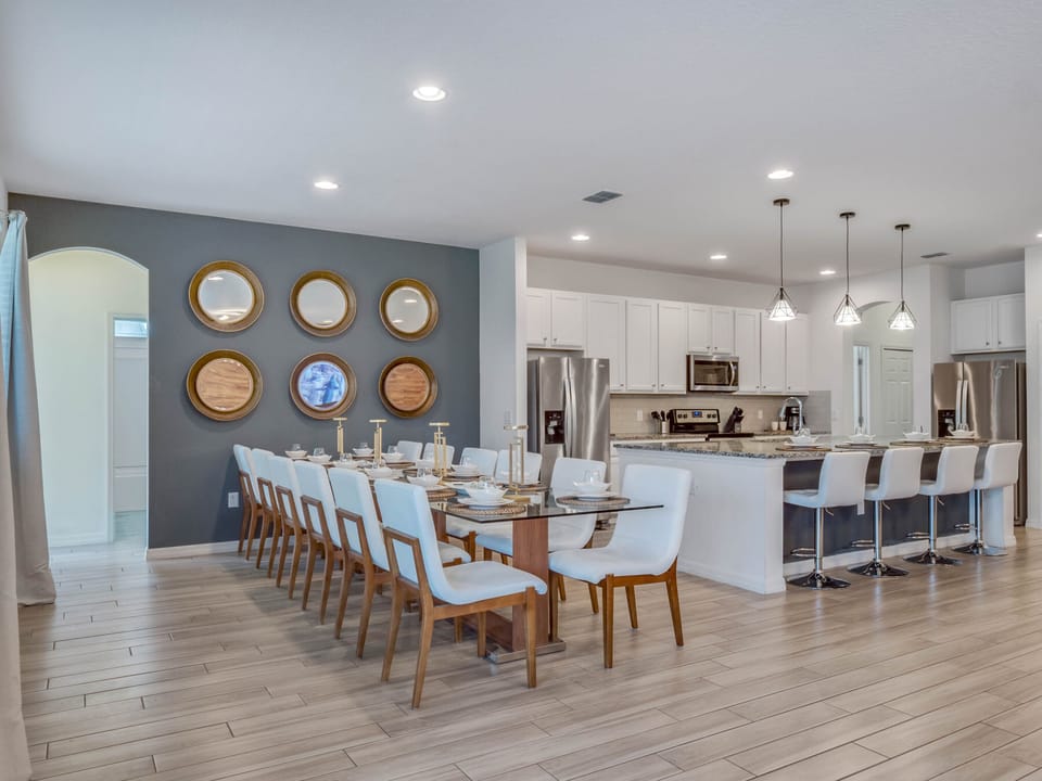 - Large dining table seats the whole group for shared meals  
- Modern kitchen with stainless appliances and bar seating  
- Perfect for cooking dining and gathering during vacation