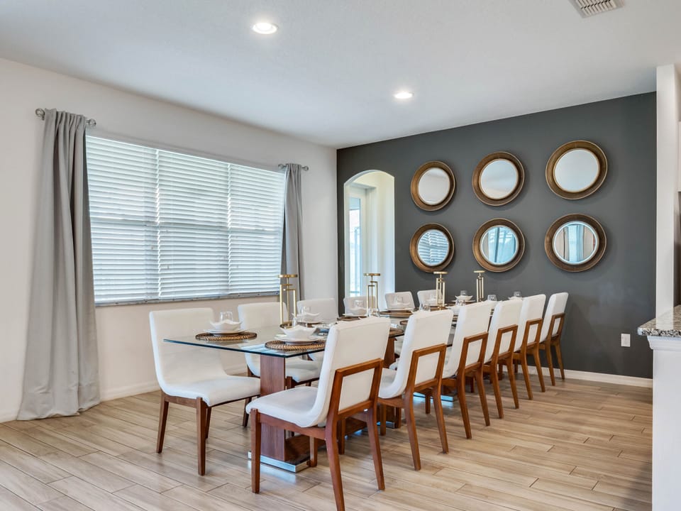 - Elegant dining area with seating for large family group meals  
- Wall decor and natural light create a stylish dining setting  
- Perfect for breakfast lunch or dinner during Orlando vacation