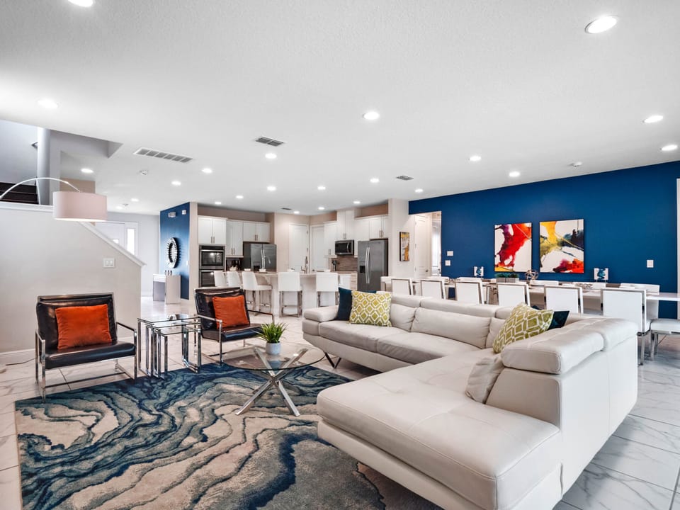 Spacious living, dining and kitchen area w/ pool views