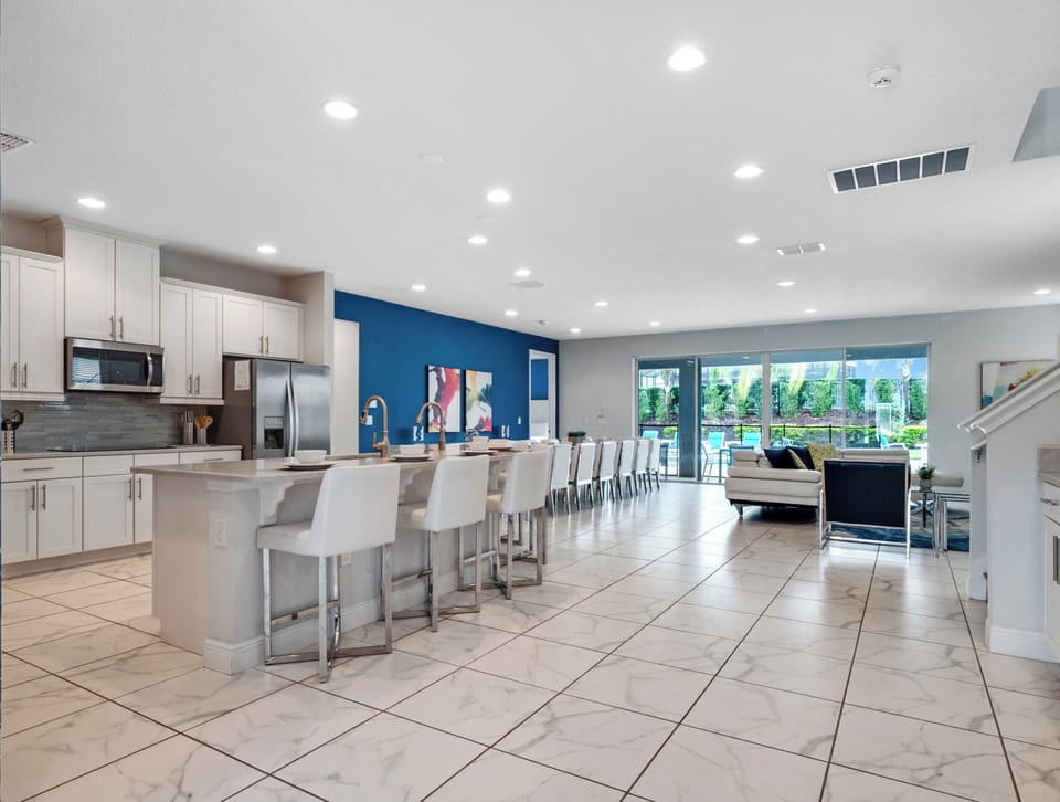 Spacious living, dining and kitchen area w/ pool views