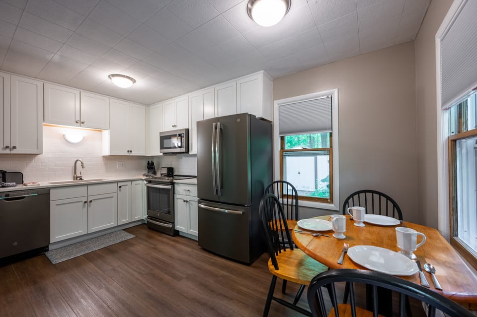 Spacious eat in kitchen with stainless appliances and enameled cabinets.