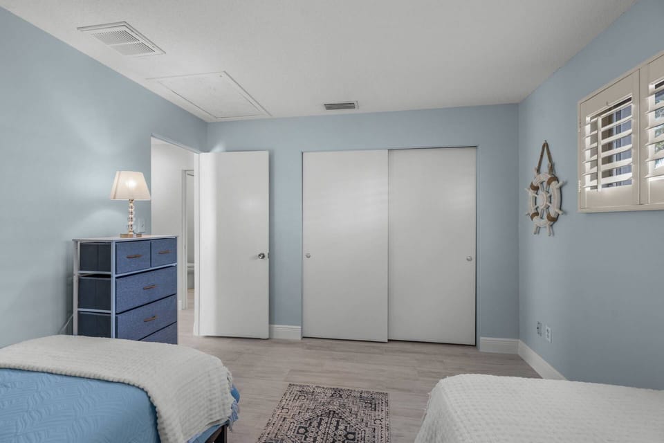 The twin guest bedroom has closet space and drawers.