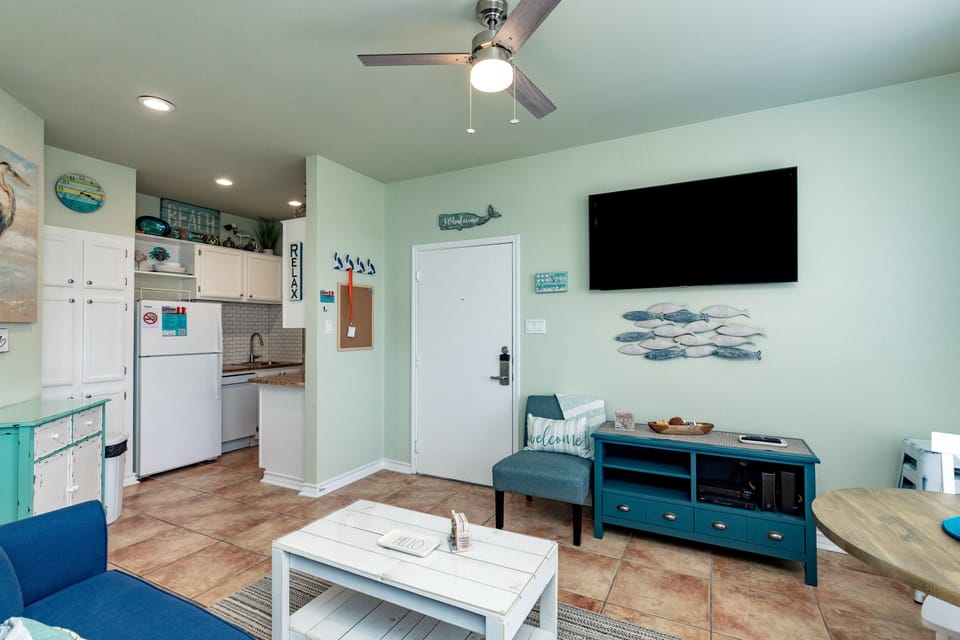 Relax in your coastal-themed retreat with full kitchen, comfortable living area, and beach-inspired decor.