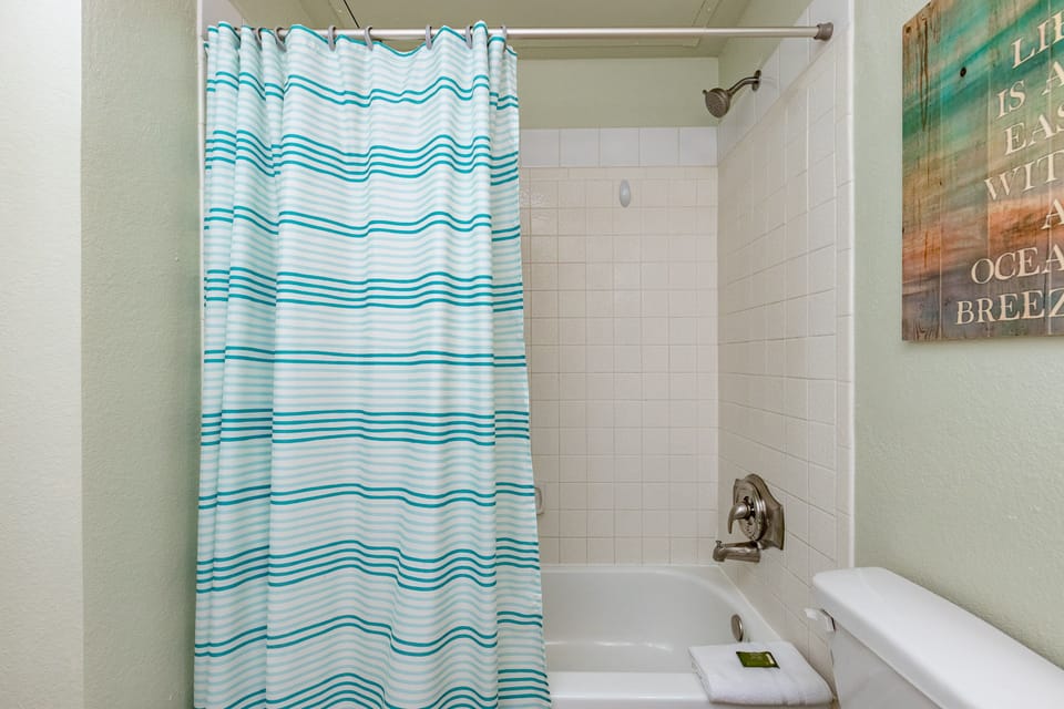 Refresh yourself in this bright bathroom with cheerful ocean-themed touches and a relaxing tub-shower combo.