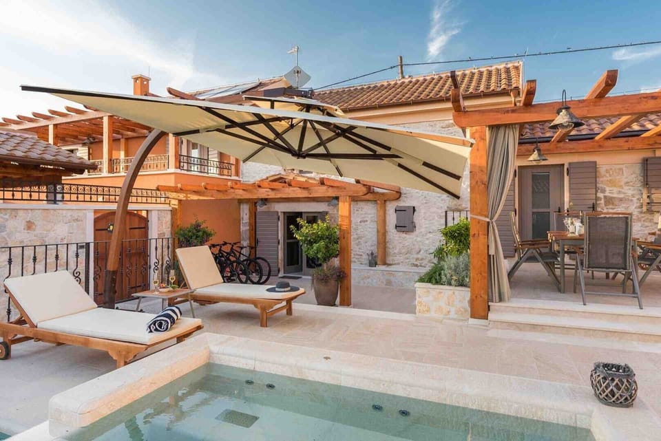 Deck chairs by the pool of a Croatian luxury vacation villa with concierge service and private parking in Skradin